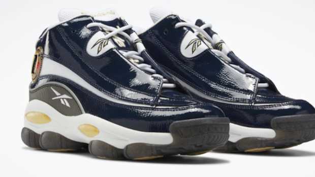 View of navy and white Reebok shoes.
